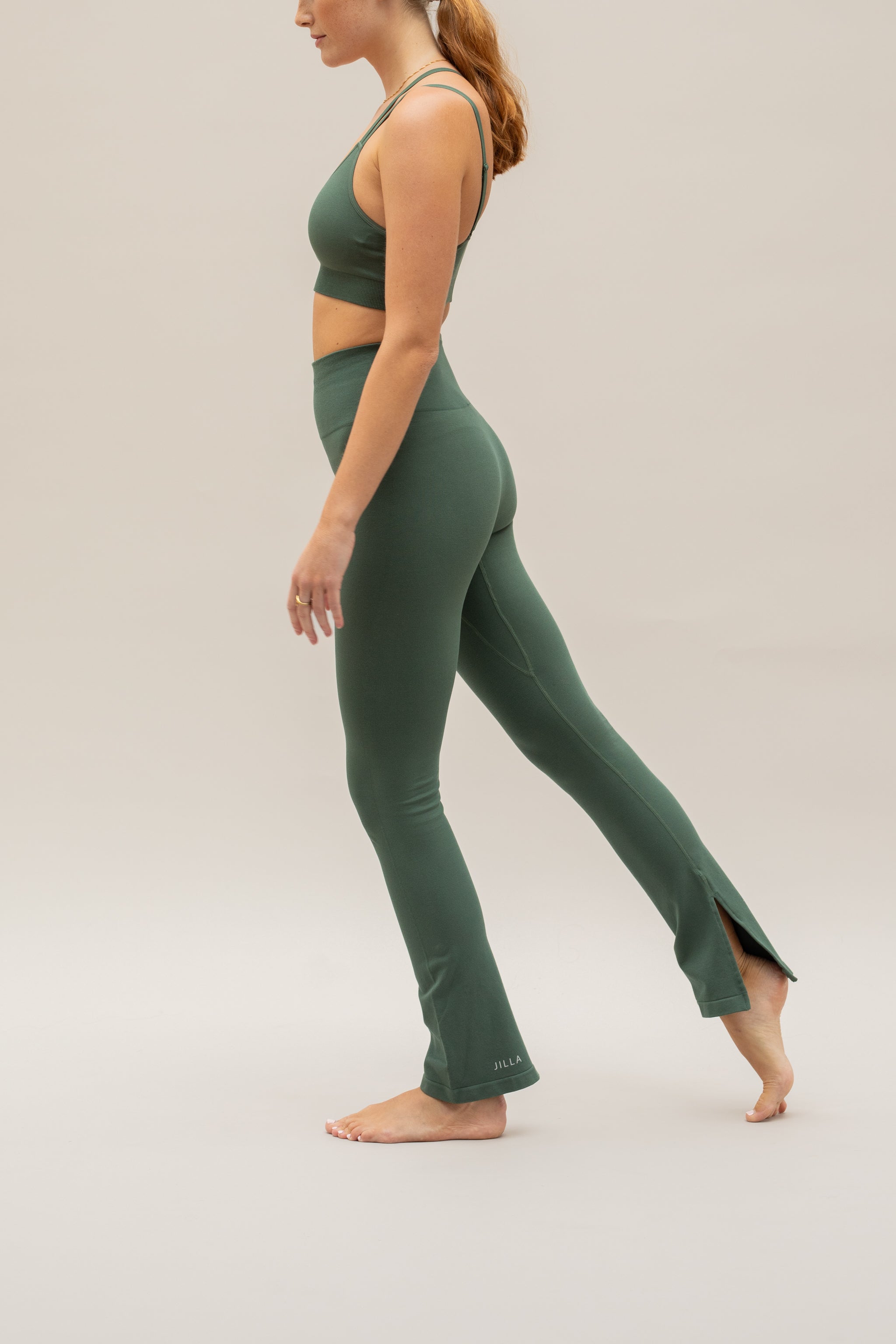 Green supportive sports bra top and green flare leggings from sustainable activewear brand, Jilla. 