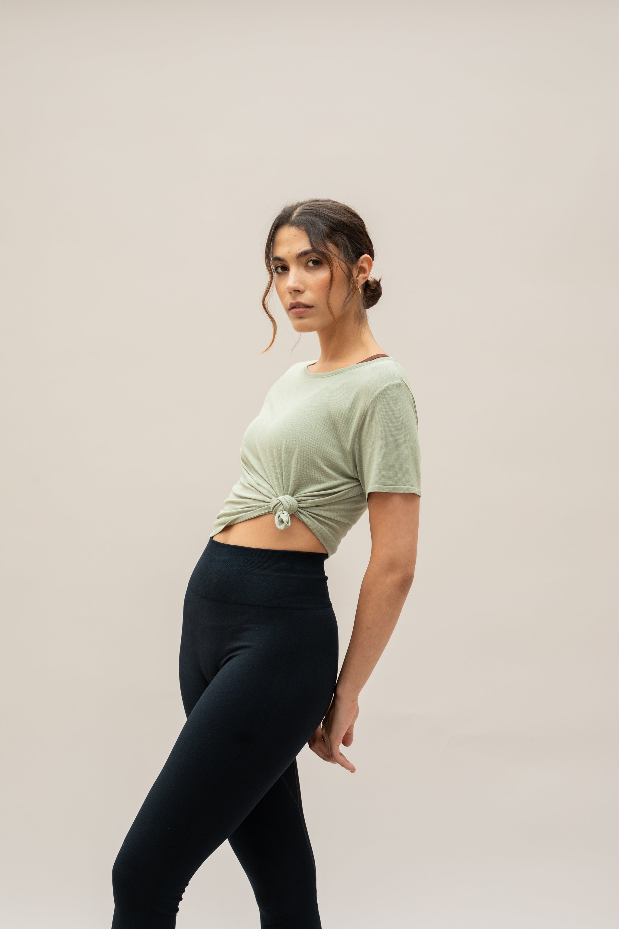 Model wearing green t-shirt for sustainable activewear brand, Jilla