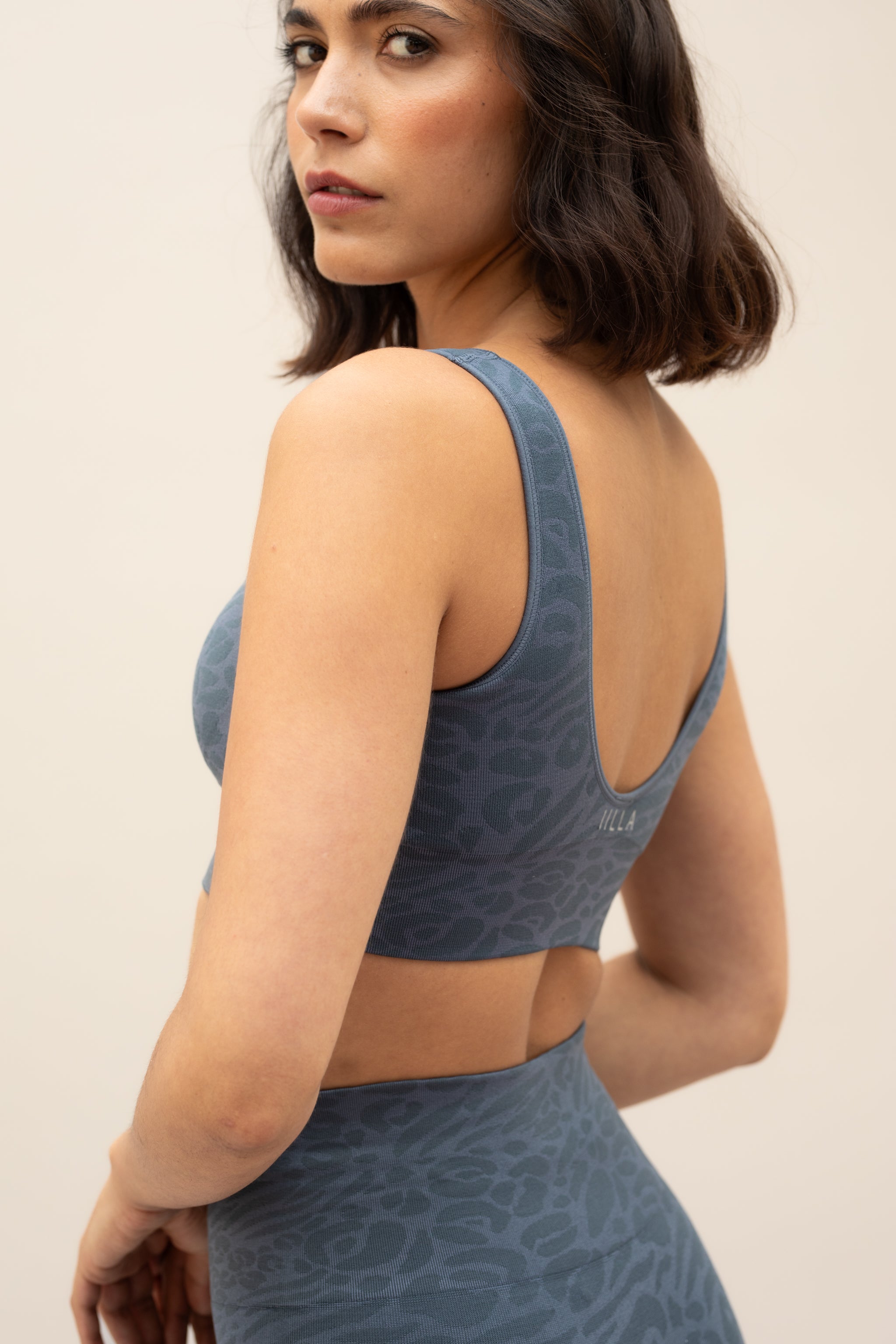 Blue leggings and blue recycled sports bra for sustainable activewear brand, Jilla.