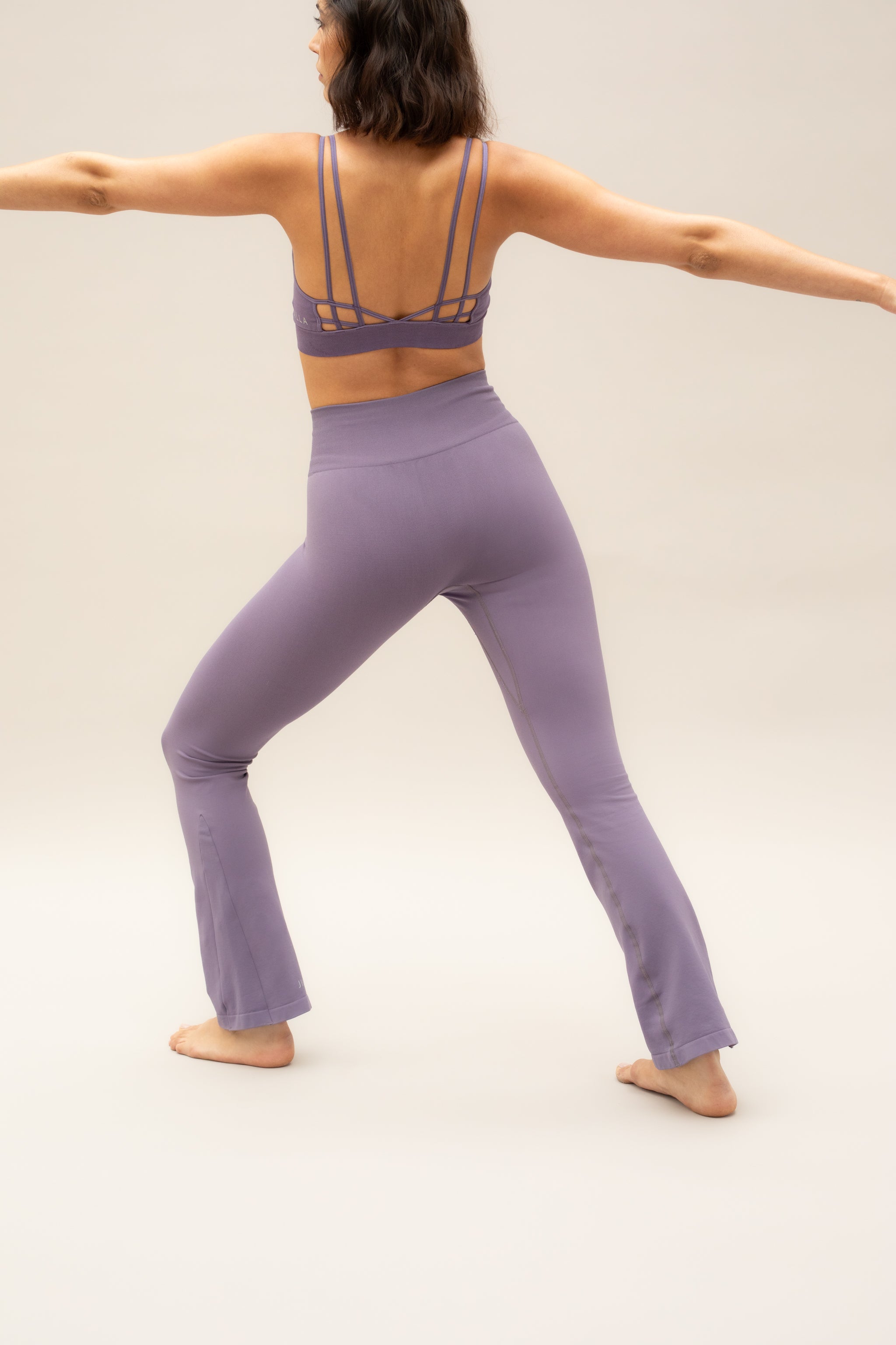 Purple flare leggings with purple supportive sports bra by sustainable women's activewear brand, Jilla. 