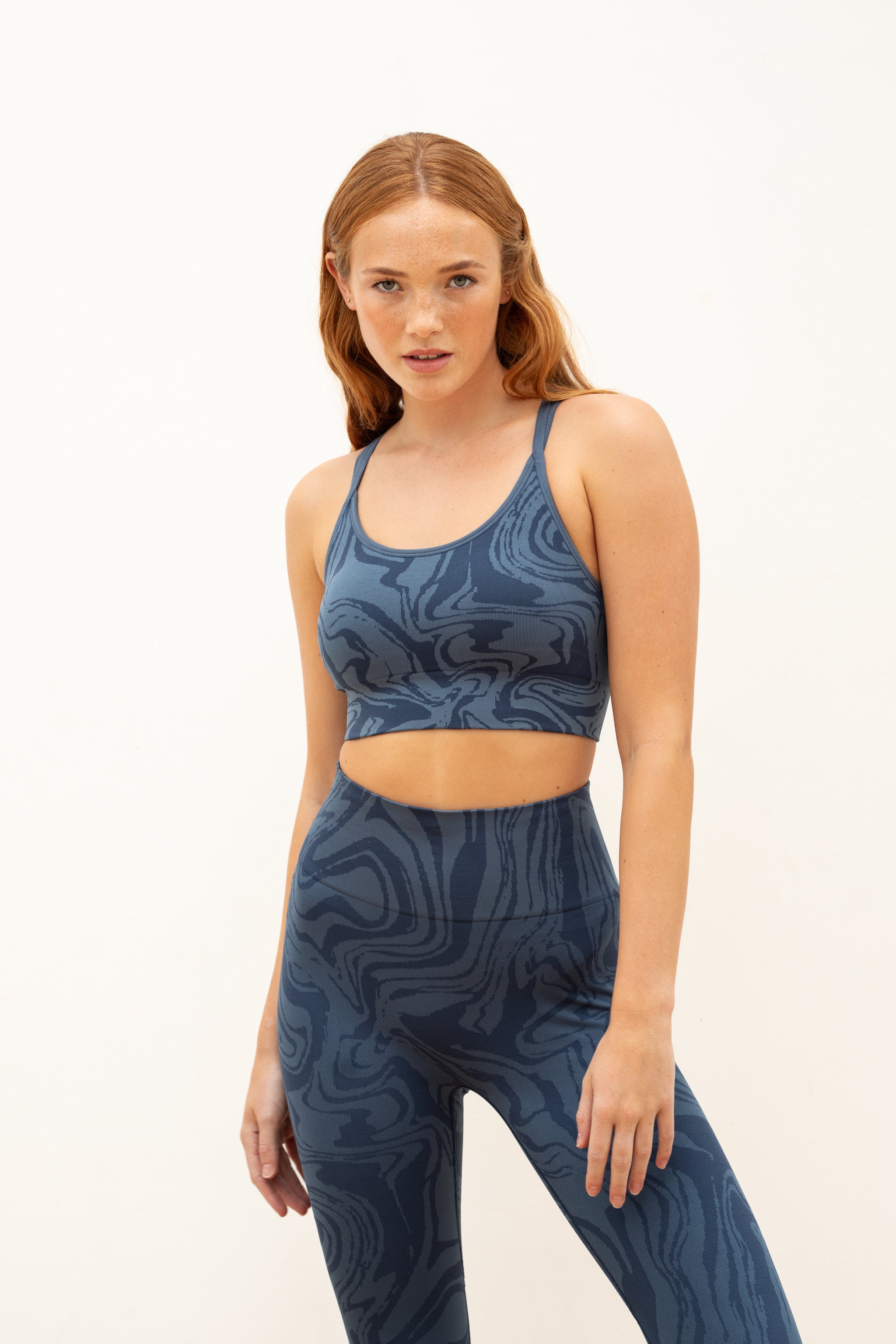 Denim blue recycled seamless marble print low to medium impact supportive sports bra for yoga, pilates, spinning, weights, running and exercise by sustainable activewear brand Jilla Active 