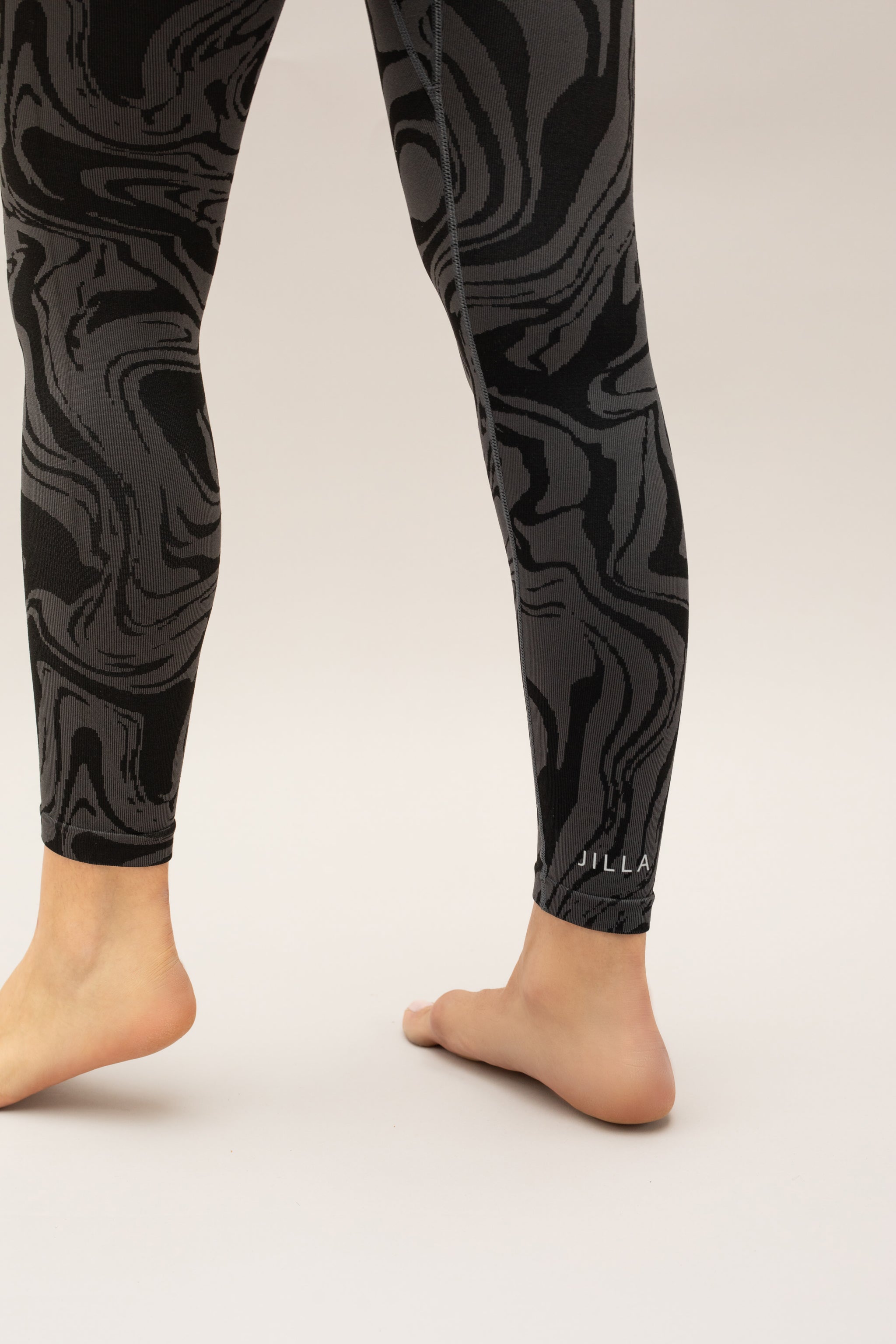 Black grey charcoal recycled seamless marble jacquard print full length high rise sculpting compressive leggings for yoga, pilates, barre, spinning, running, cycling and exercise by sustainable activewear brand Jilla Active