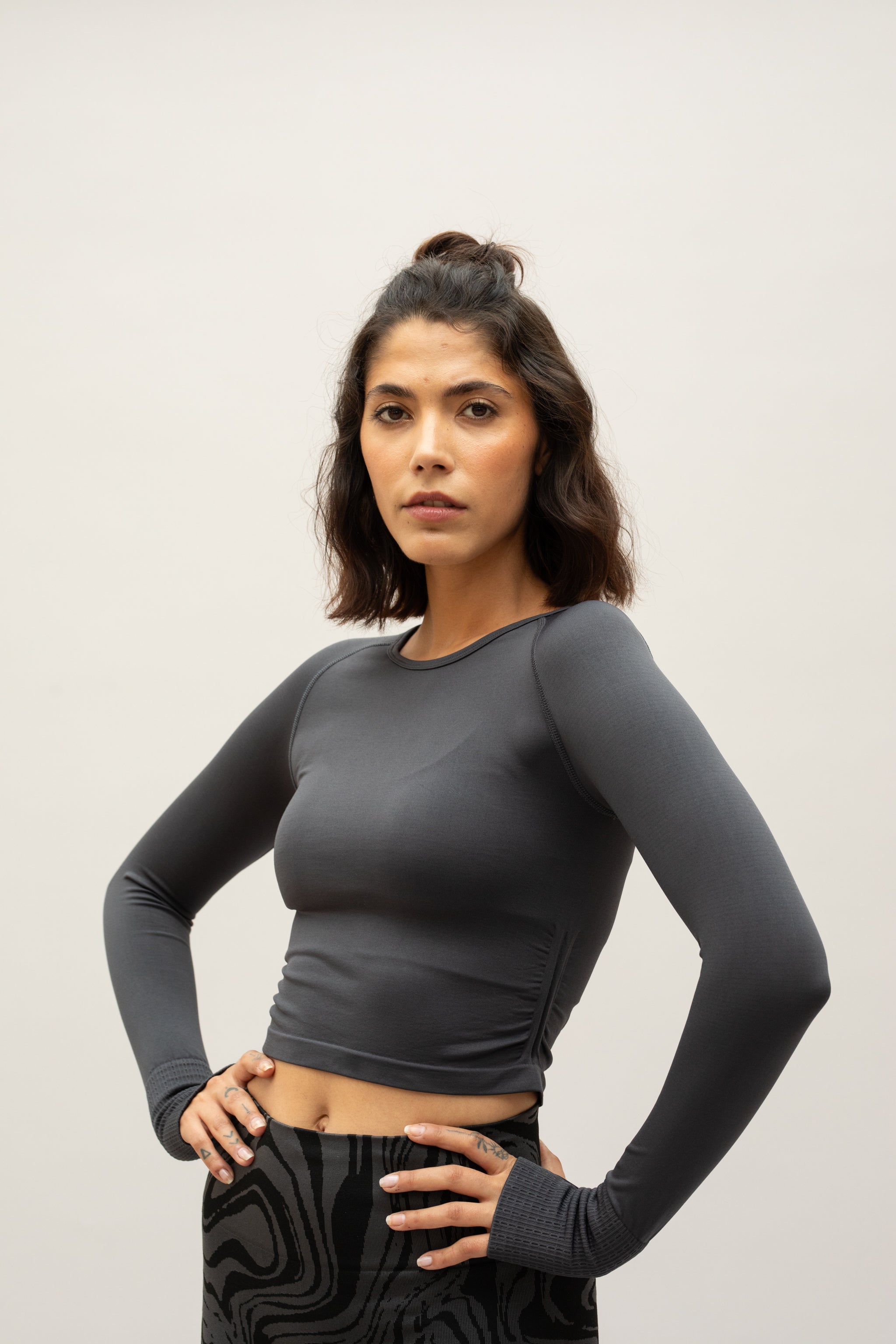 Black long sleeve recycled crop top with black leggings from sustainable women's activewear brand, Jilla.