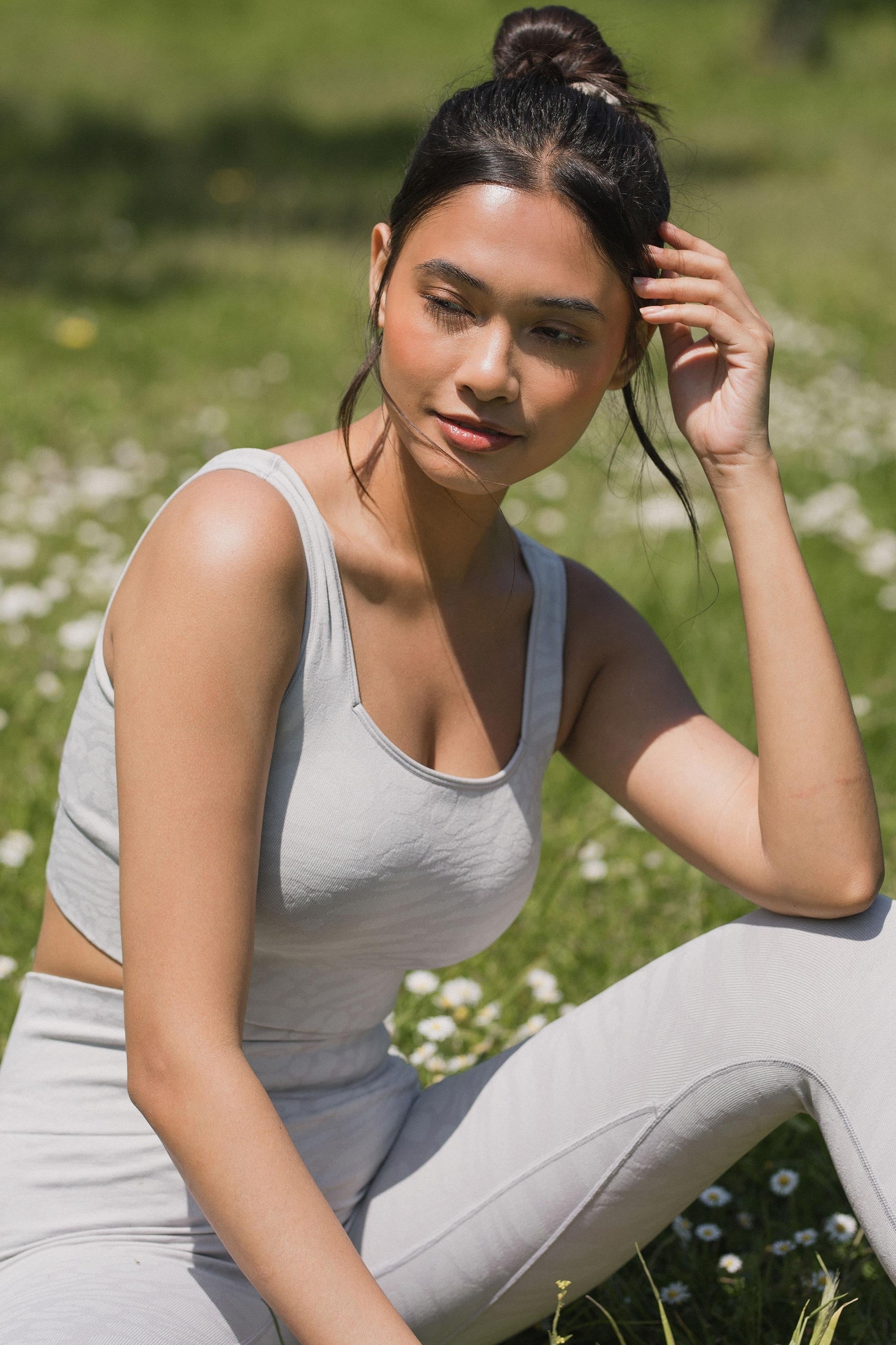 Model wearing grey leggings and grey recycled sports bra for sustainable activewear brand, Jilla.