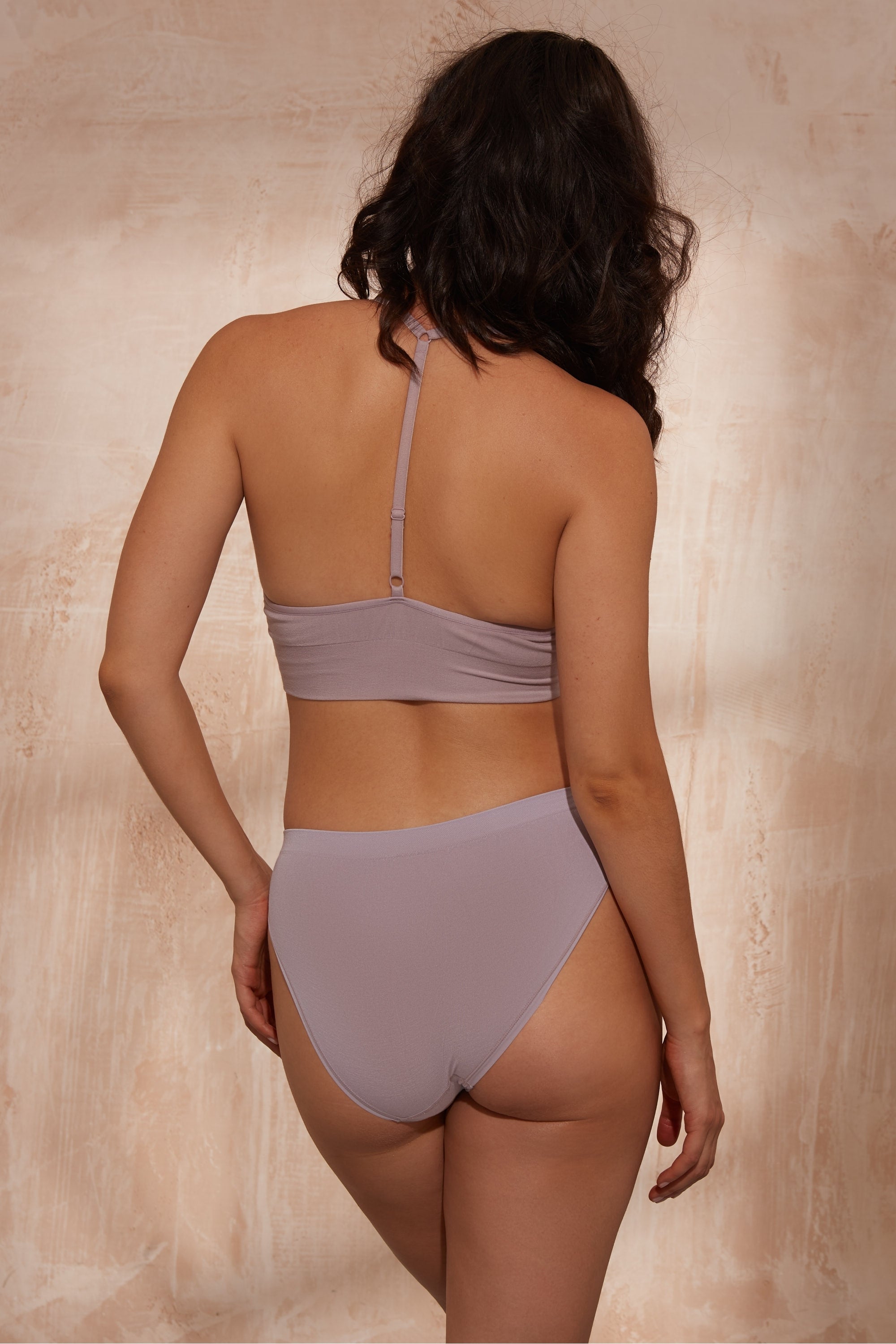 Model wearing lilac top and lilac briefs for sustainable activewear brand, Jilla.