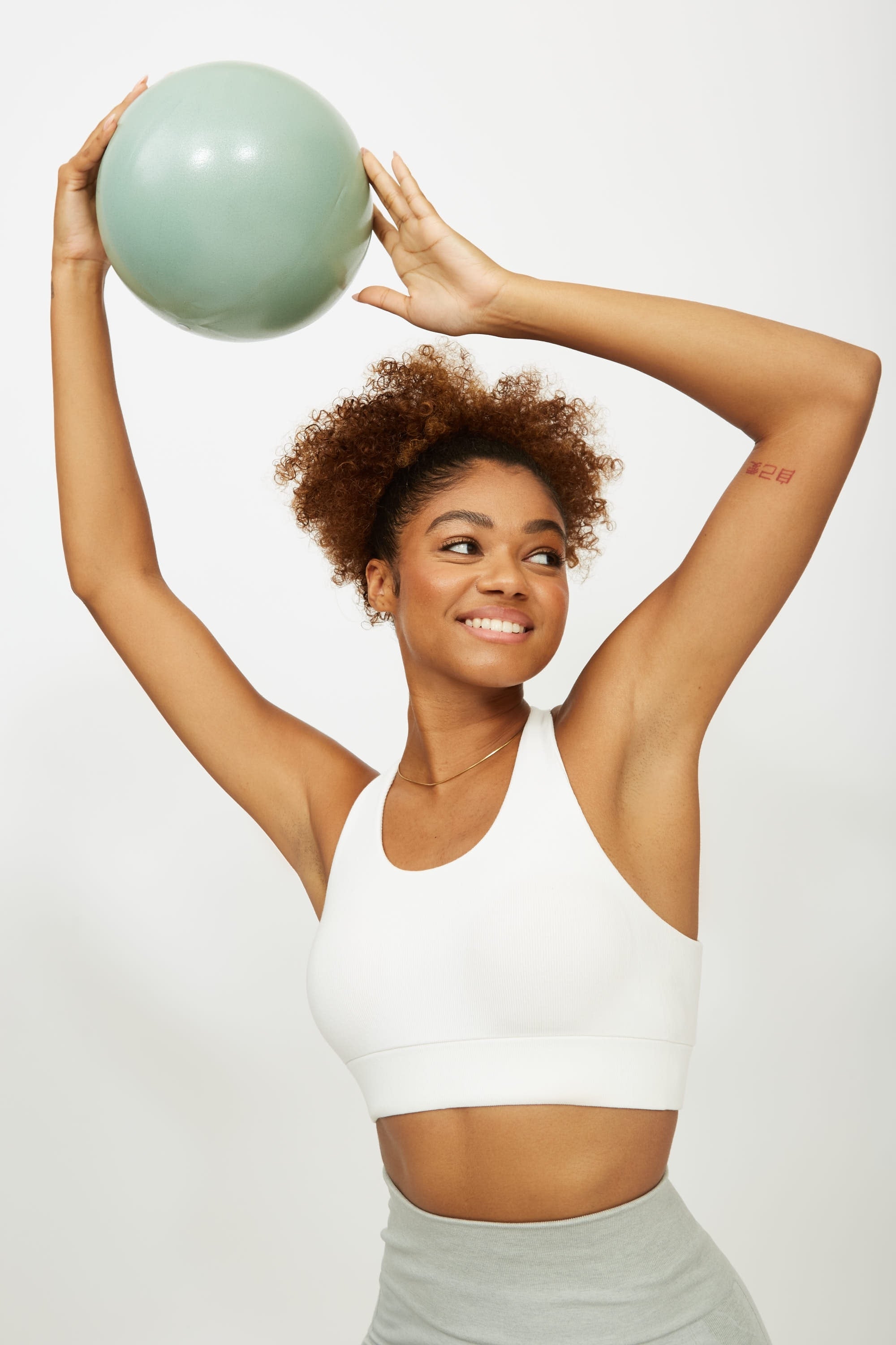 Model wearing white supportive sports bra for sustainable activewear brand, Jilla.