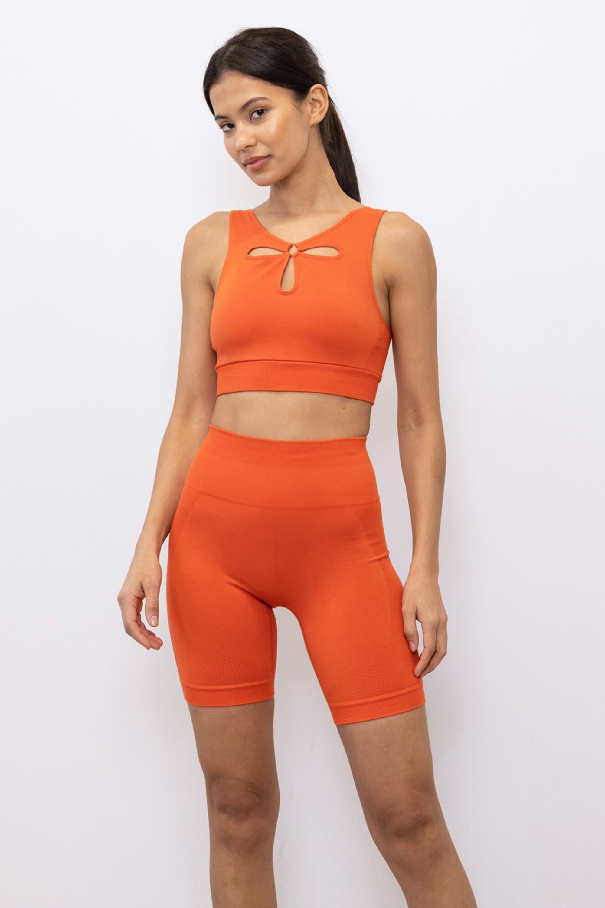 Bright orange ribbed recycled modal shorts and padded supportive sculpting sports bra for running, yoga, gym and pilates from sustainable activewear brand Jilla Active 