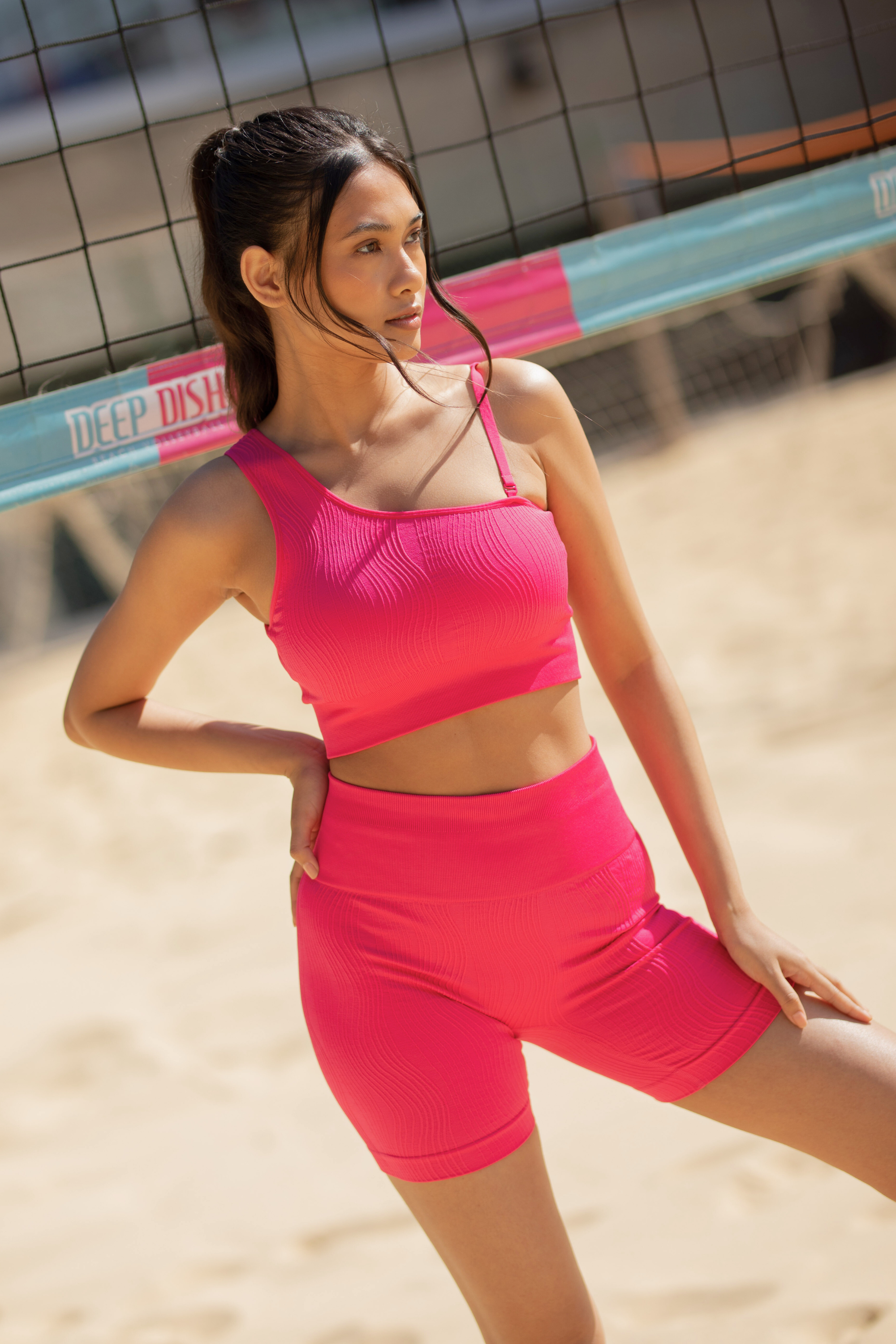 Model wearing pink leggings and pink supportive sports bra for sustainable activewear brand, Jilla.