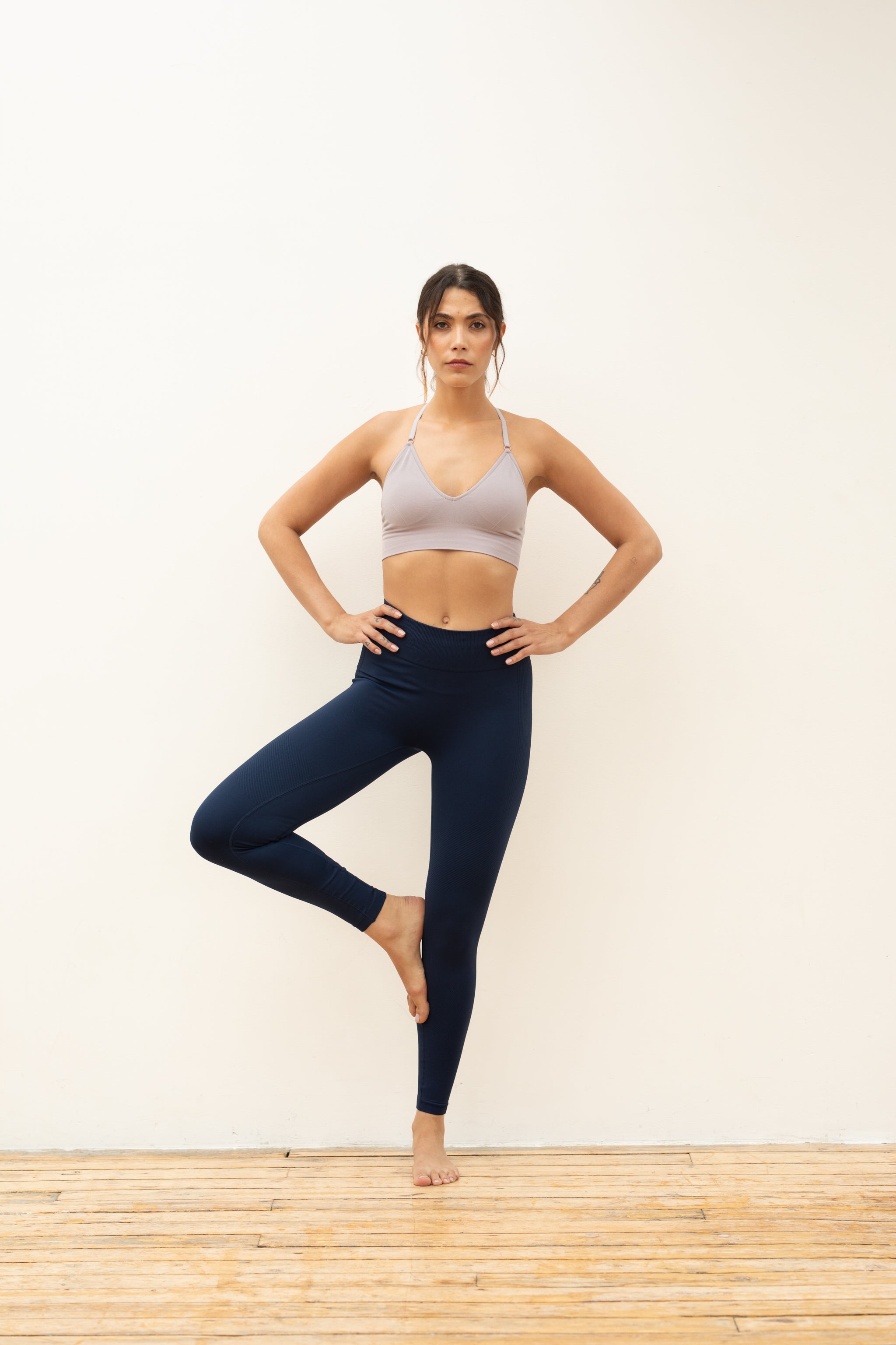 Navy blue high rise full length legging and soft pink bra from recycled fabrics for yoga, pilates, barre, gym and running from sustainable activewear brand Jilla Active 