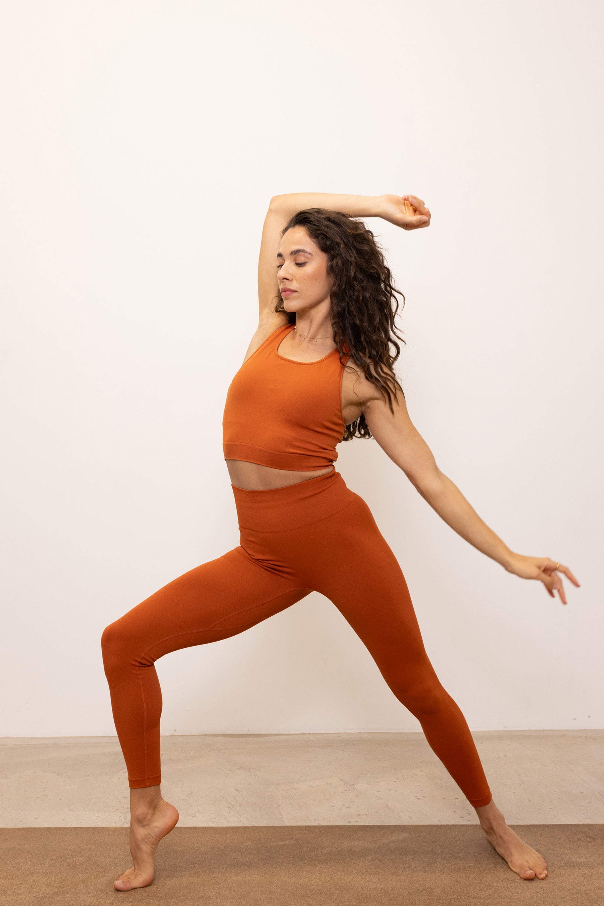 Burnt orange longline supportive sports bra cropped top with removable pads and built in bra with matching leggings for yoga, gym, pilates and exercise by sustainable activewear brand Jilla Active 