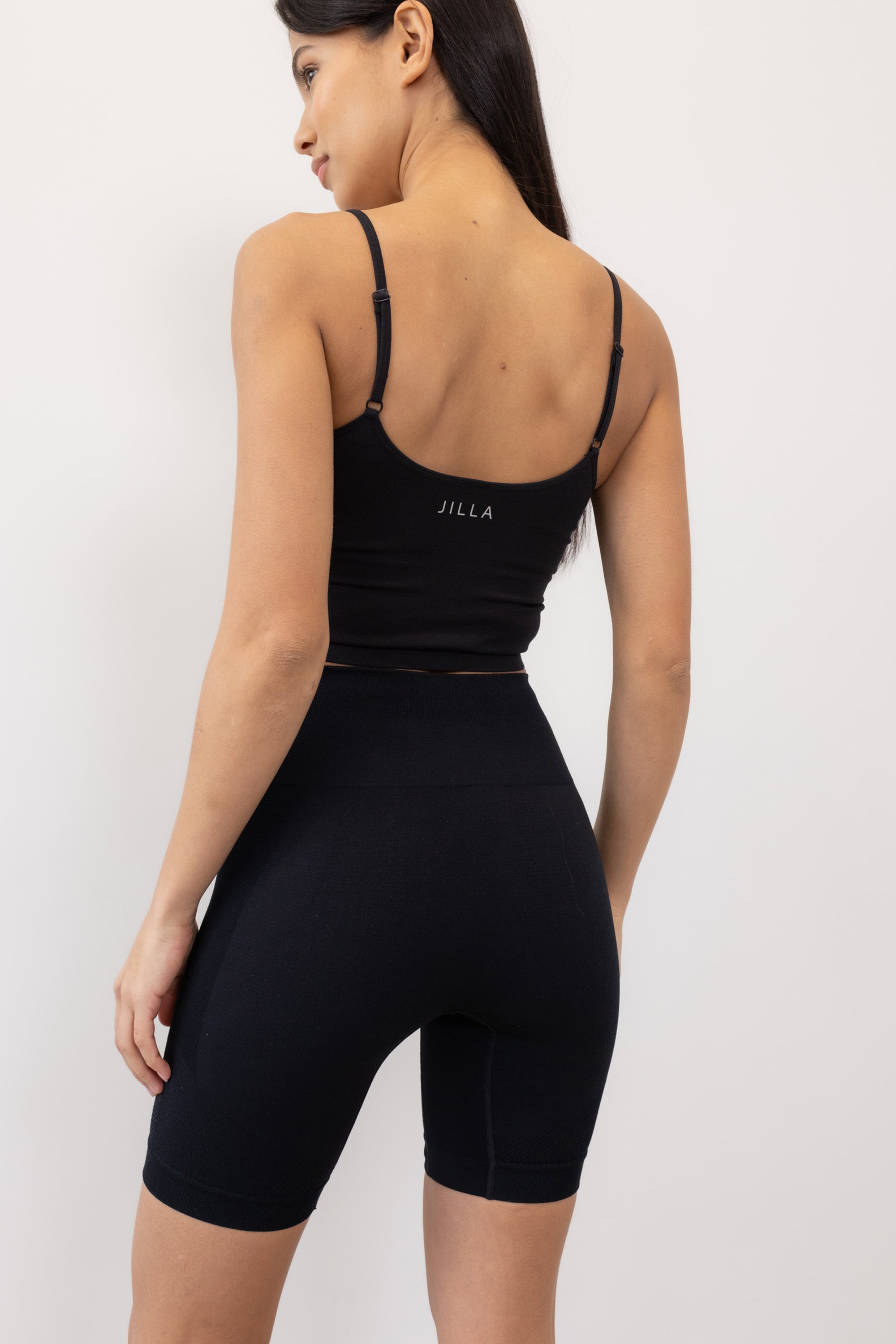 Black ribbed recycled modal shorts and padded supportive sculpting sports bra for running, yoga, gym and pilates from sustainable activewear brand Jilla Active
