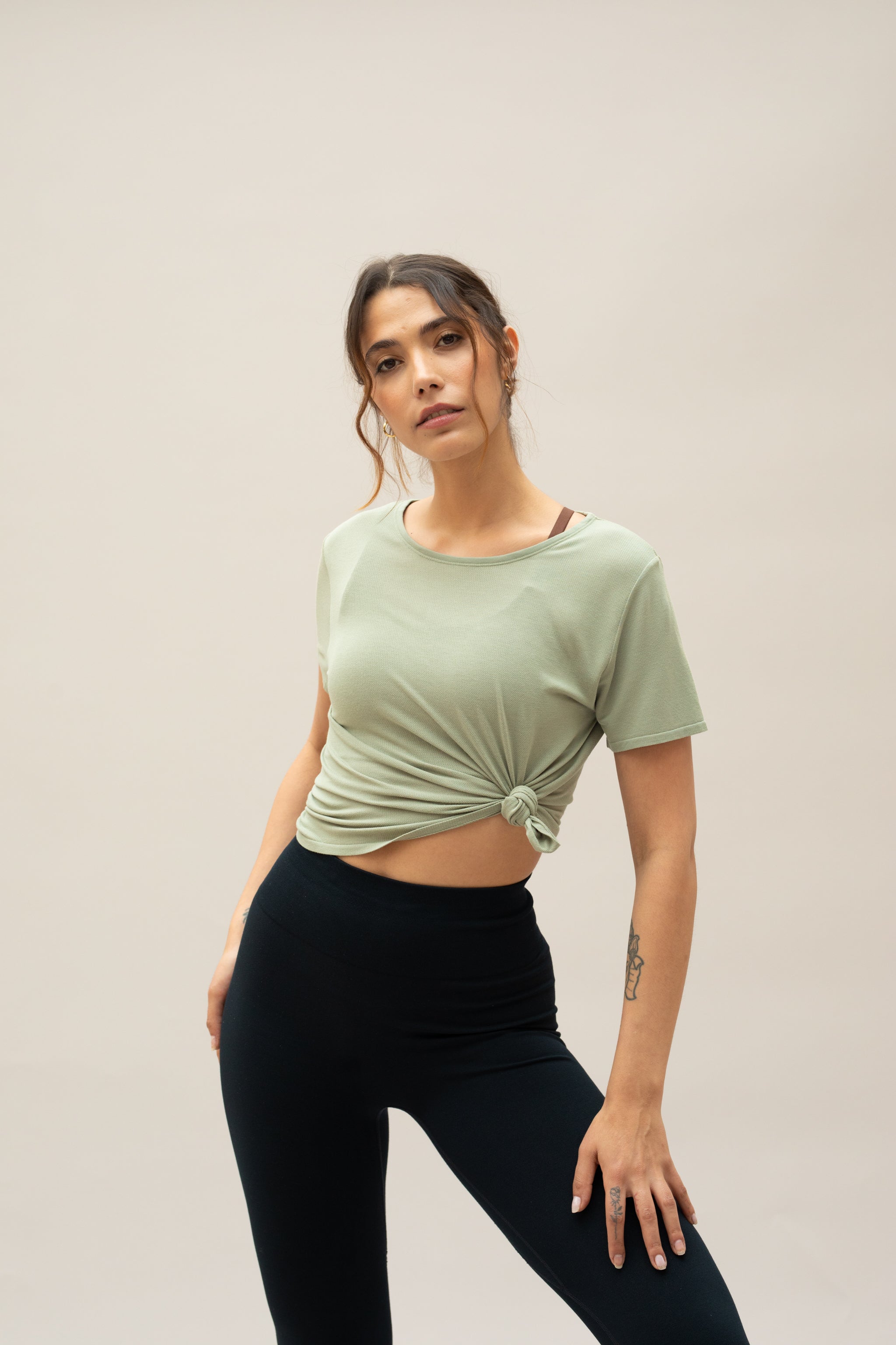 Model wearing green t-shirt for sustainable activewear brand, Jilla
