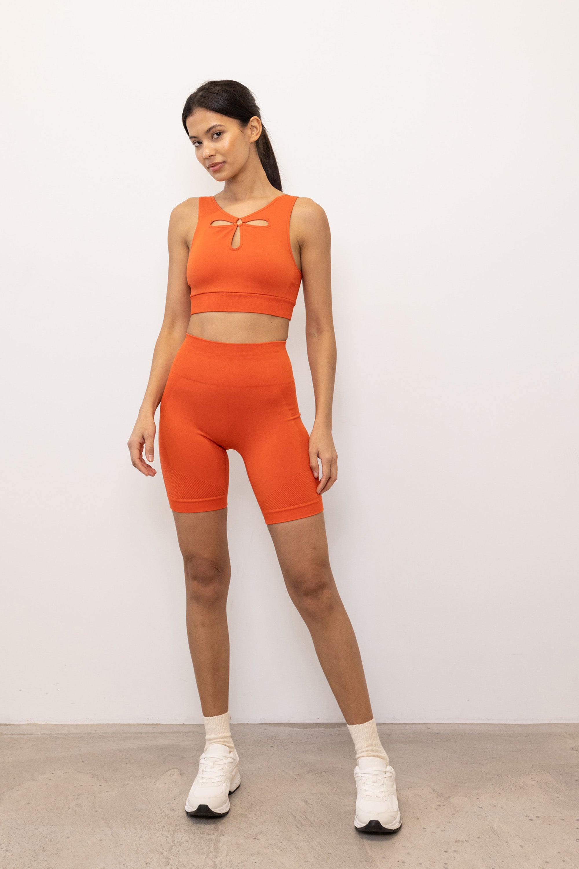 Bright orange ribbed recycled modal shorts and padded supportive sculpting sports bra for running, yoga, gym and pilates from sustainable activewear brand Jilla Active  Edit alt text