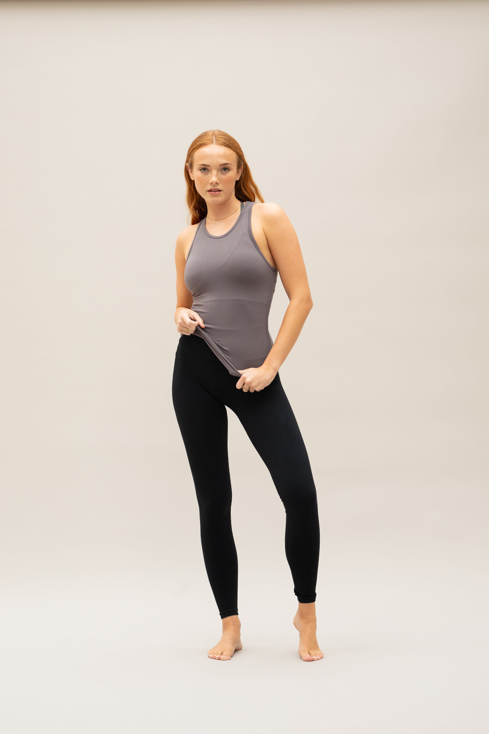 Model wearing grey recycled yoga top for sustainable women's activewear brand Jilla