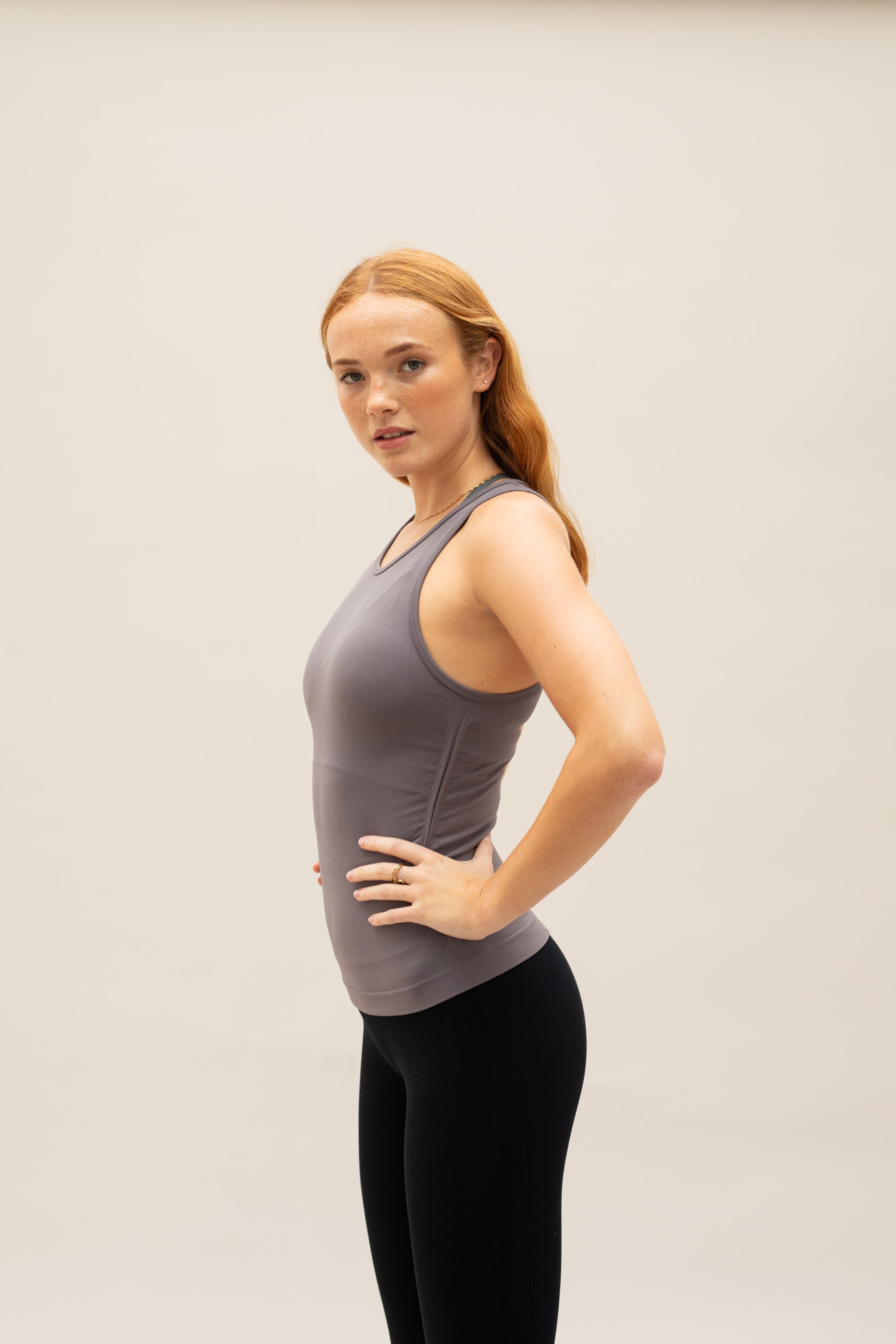 Model wearing grey recycled yoga top for sustainable women's activewear brand Jilla