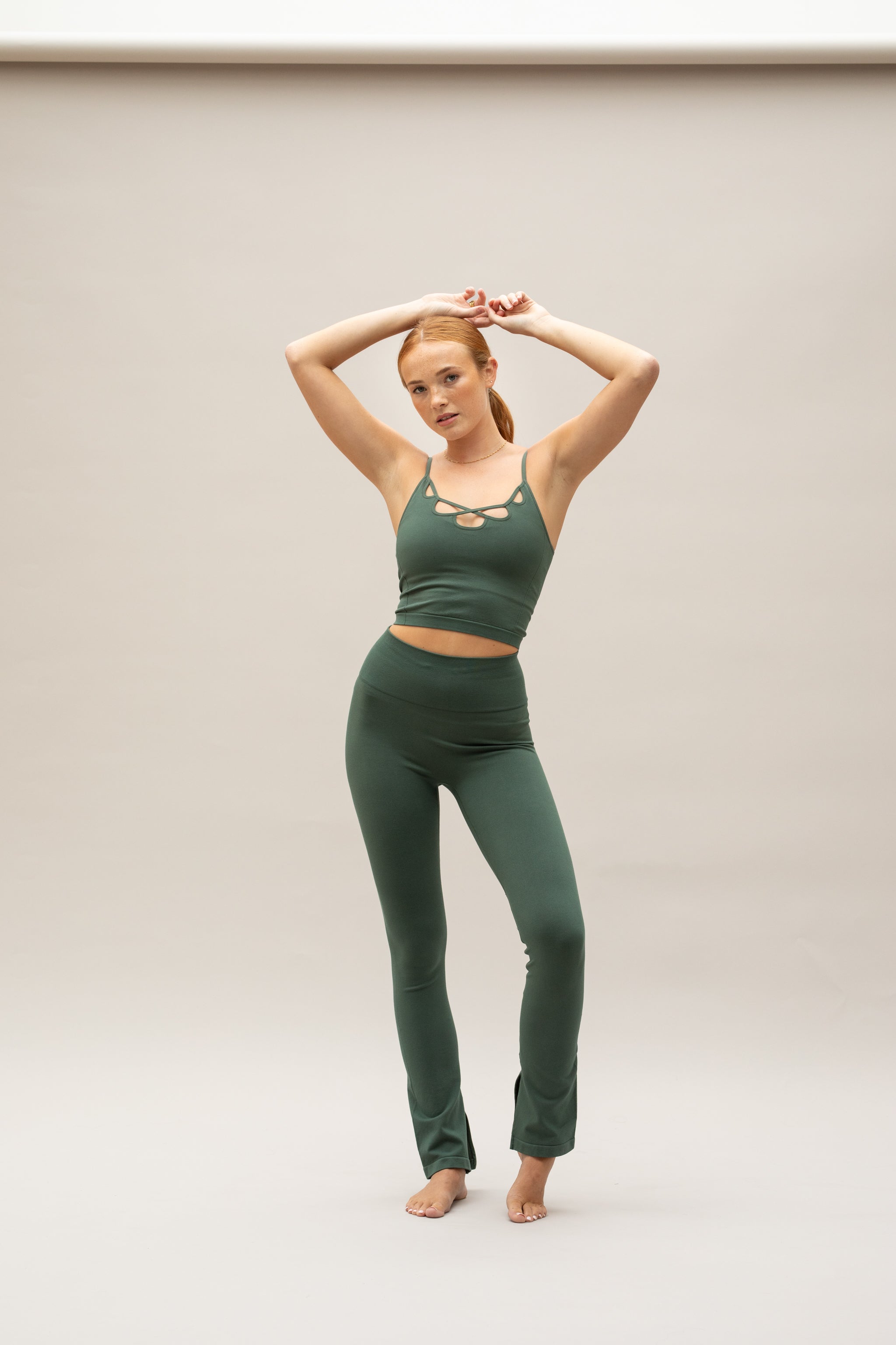 Green supportive sports bra top and green flare leggings from sustainable activewear brand, Jilla. 