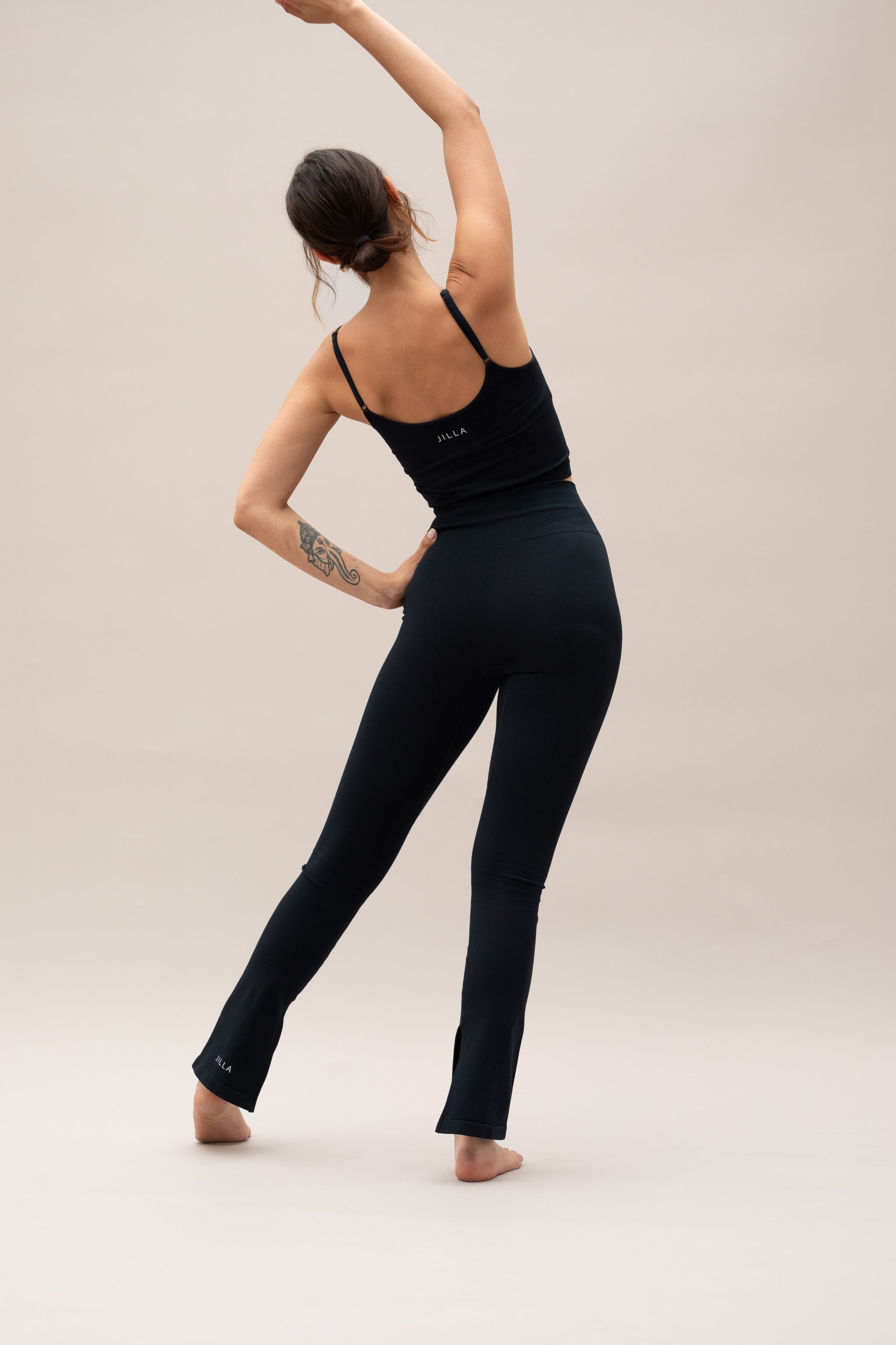 Model wearing black top and black leggings for sustainable activewear Jilla