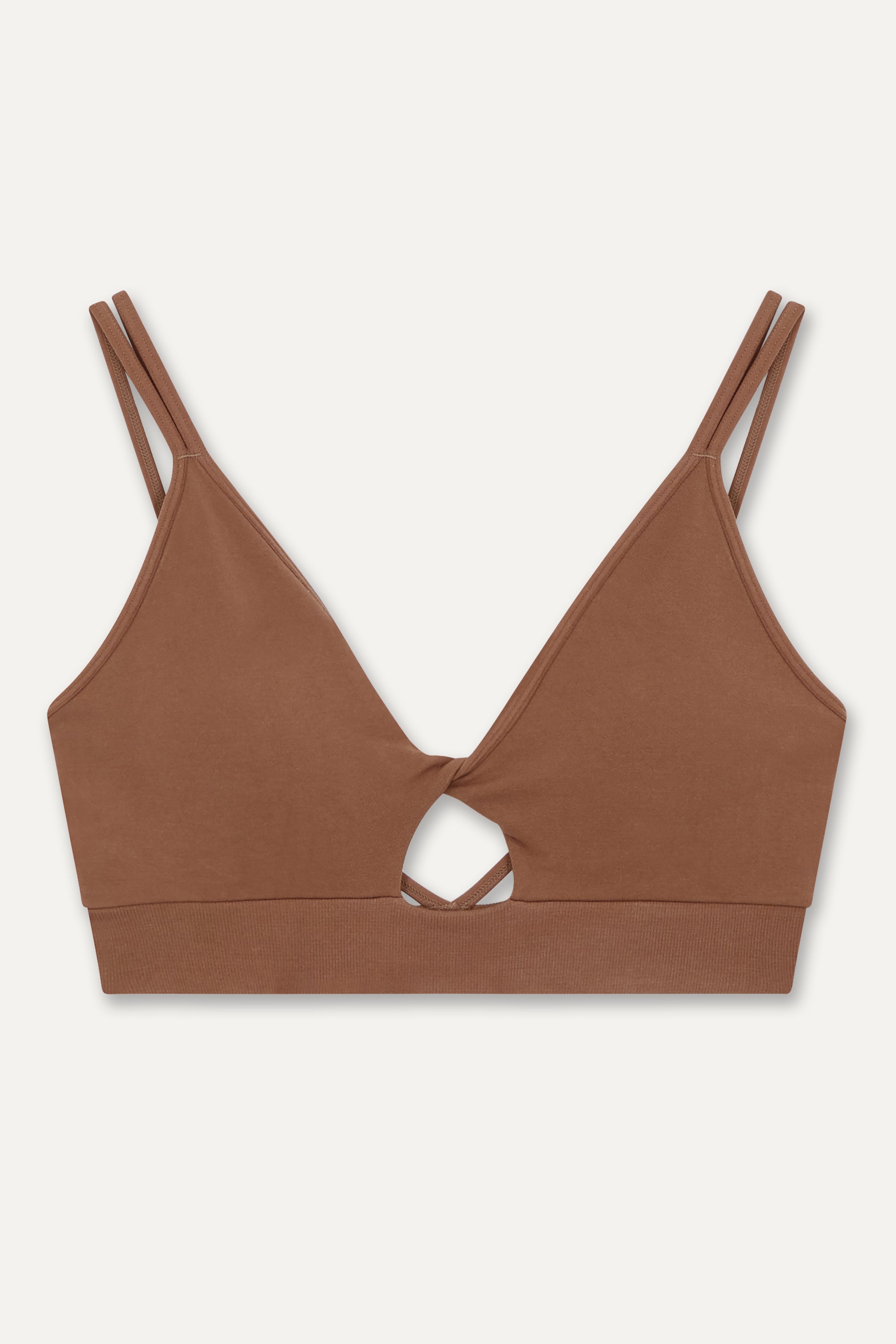 Brown supportive twisted from sports bra and brown high waisted flare leggings from sustainable activewear brand, Jilla.  Edit alt text