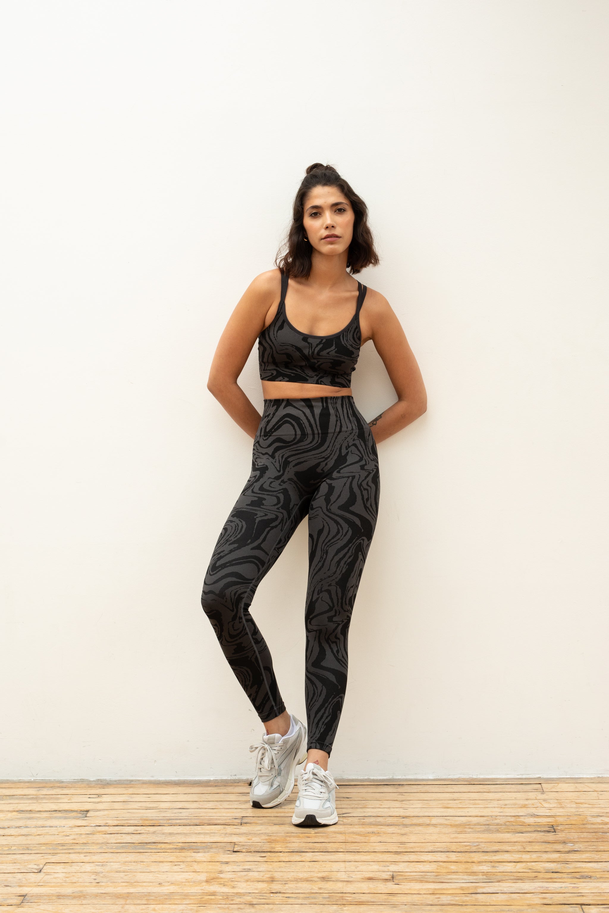 Black and grey jacquard marble effect supportive sports bra with high waisted leggings by sustainable women's activewear brand, Jilla.