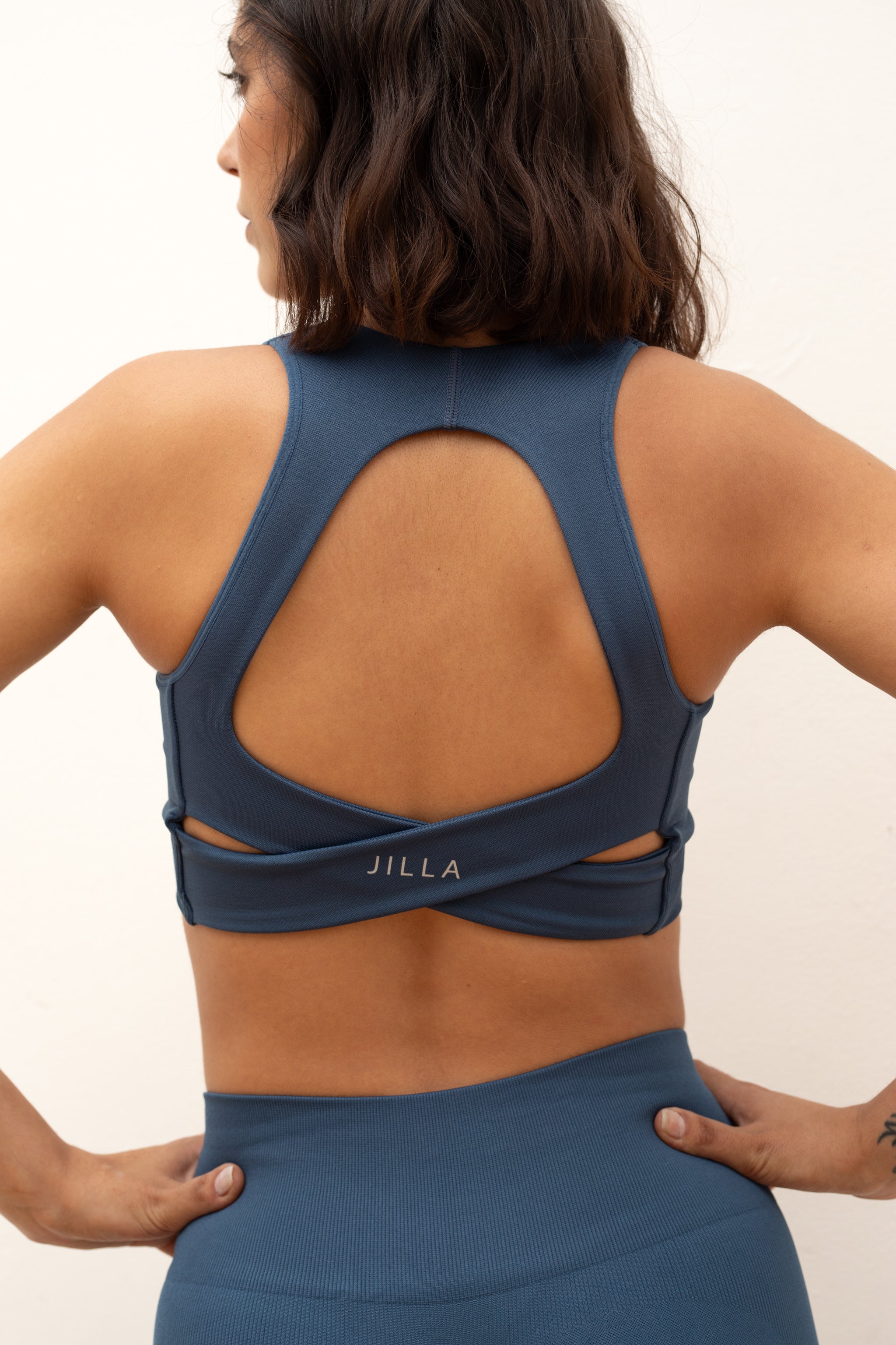 Blue V neck recycled supportive sports bra and leggings from sustainable women's activewear brand Jilla