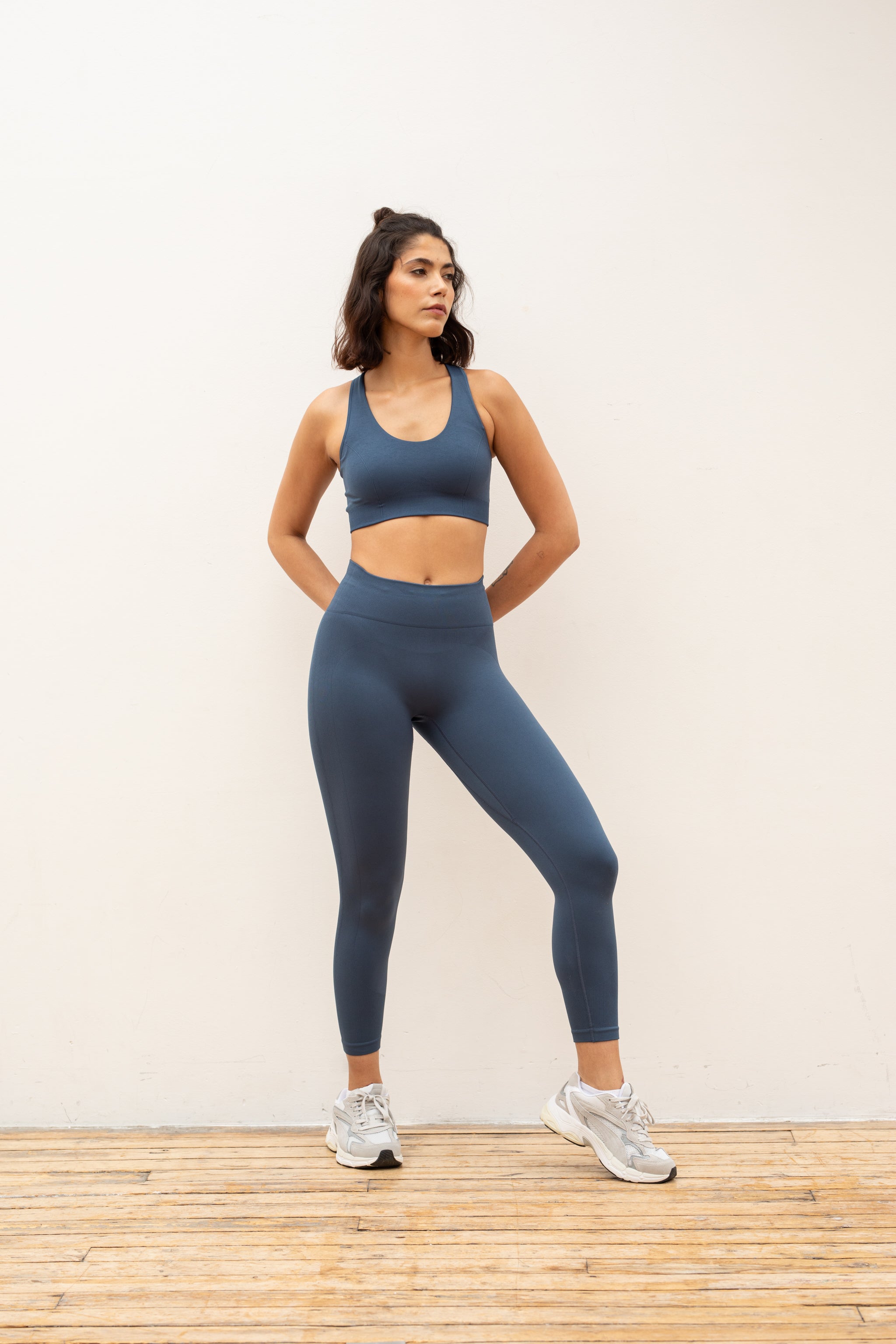 Blue recycled supportive sports bra and high waisted cropped leggings from sustainable women's activewear brand Jilla