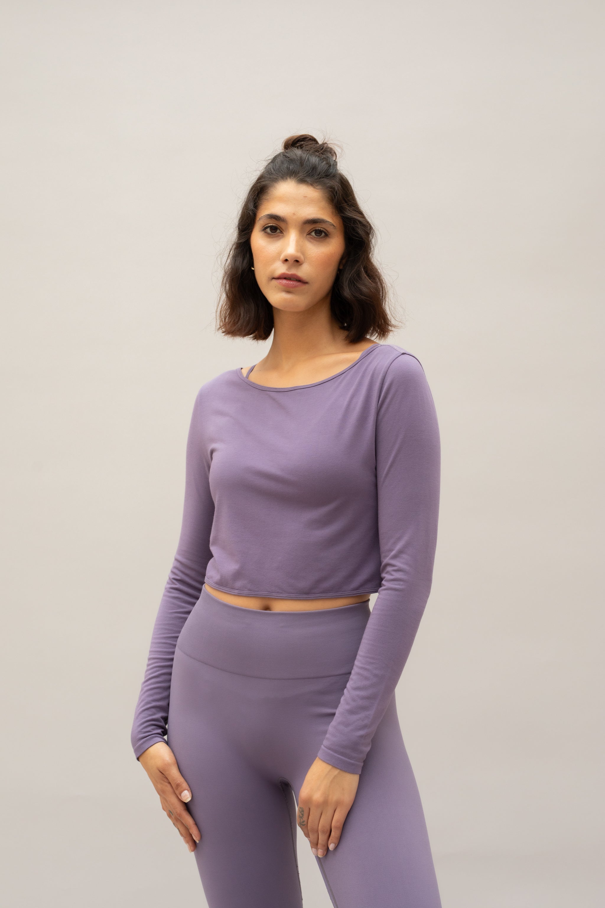 Purple lilac cropped supportive sports bra with long sleeve cropped twisted front top and high waist leggings 