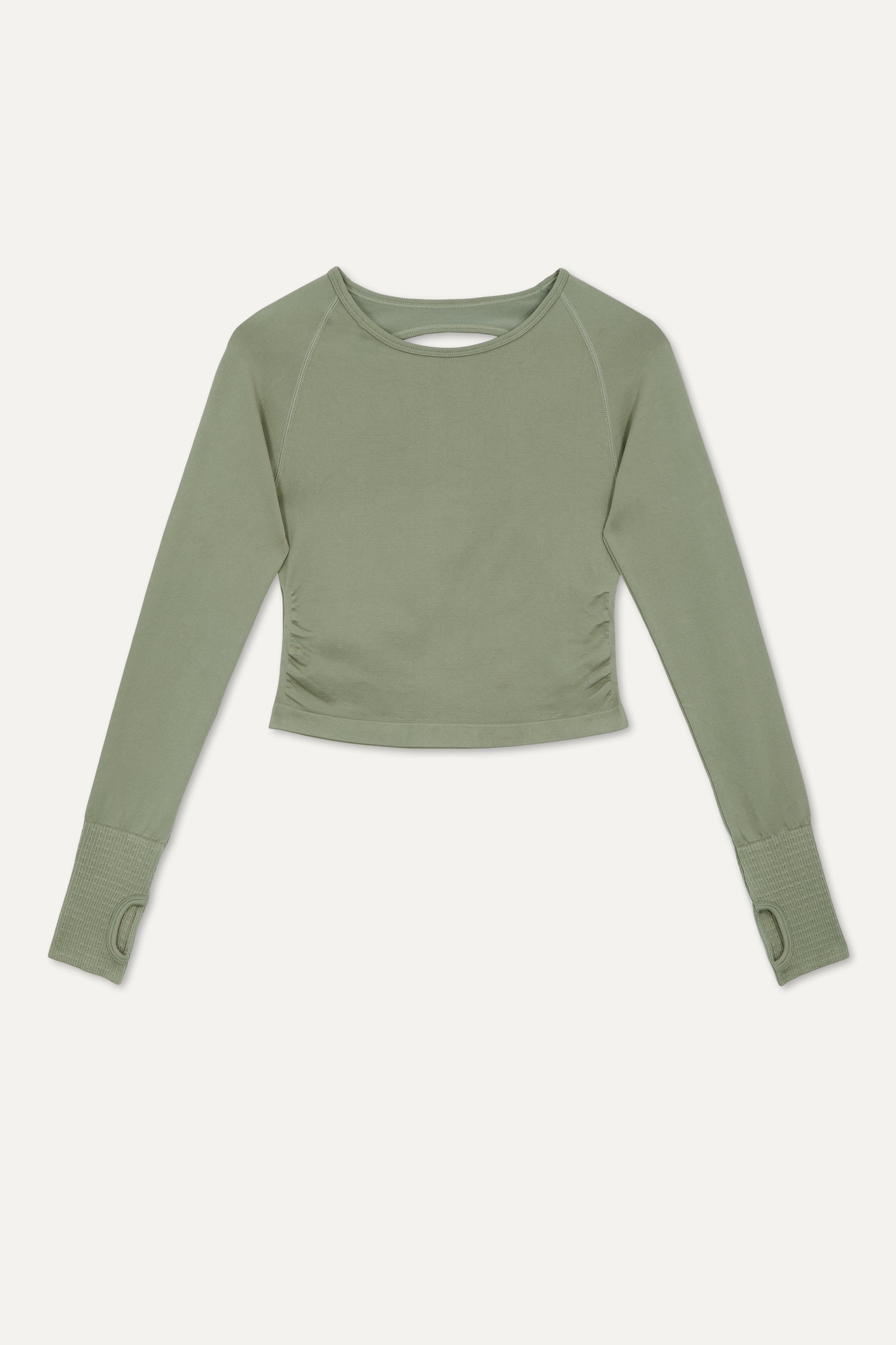 Seagrass green cutout back cropped long sleeve top with thumbholes and side ruching made from recycled fabrics for yoga, pilates, cycling, gym and exercise by sustainable activewear brand Jilla Active  Edit alt text