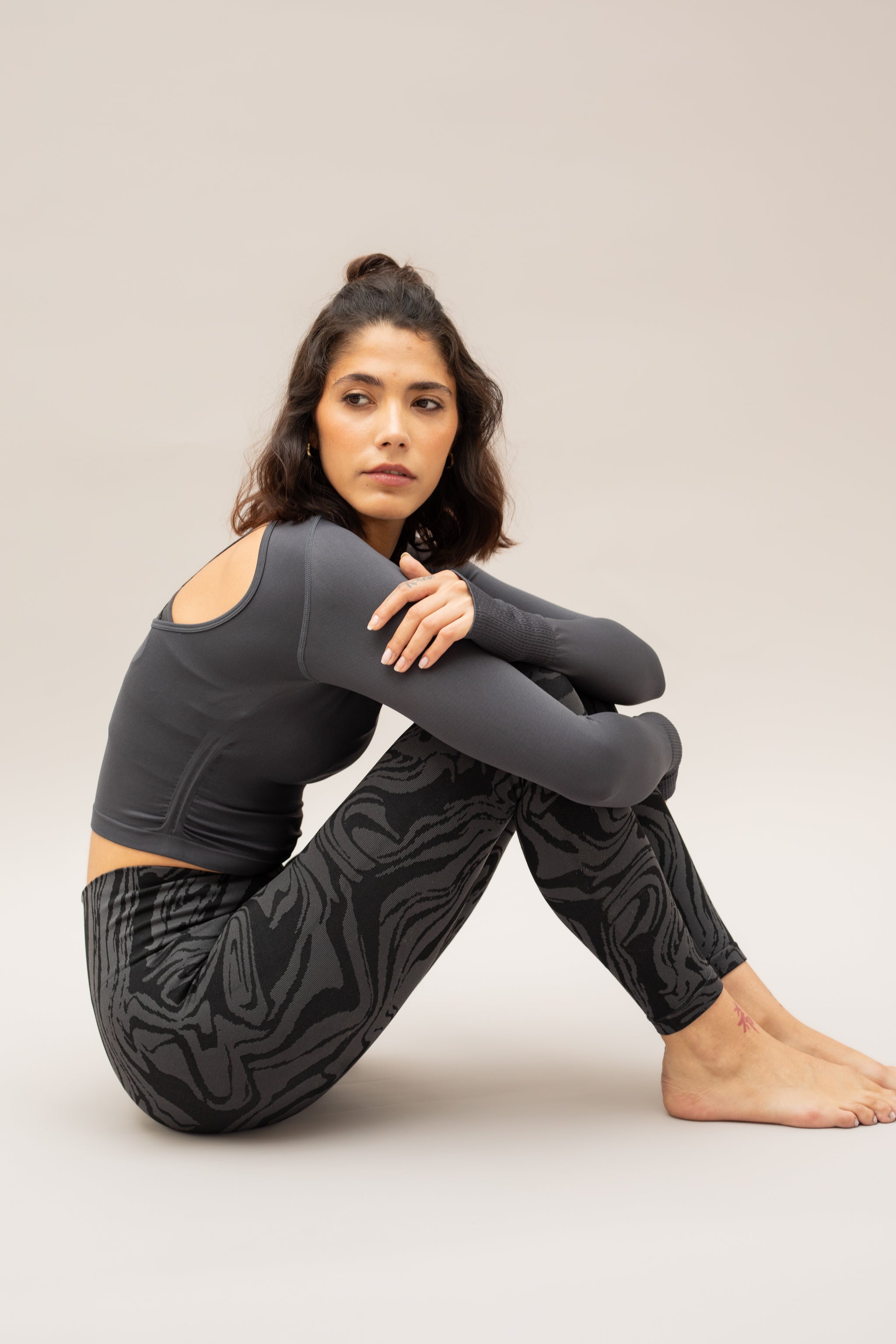 Black long sleeve recycled crop top with black leggings from sustainable women's activewear brand, Jilla. 