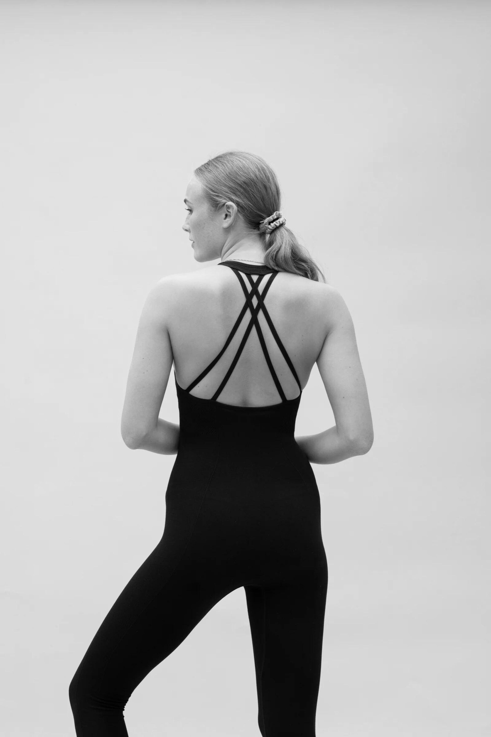 Black seamless sculpting shaping one piece bodysuit with built in shelf bra and removable pads for yoga, pilates, gym and exercise by sustainable activewear brand Jilla Active