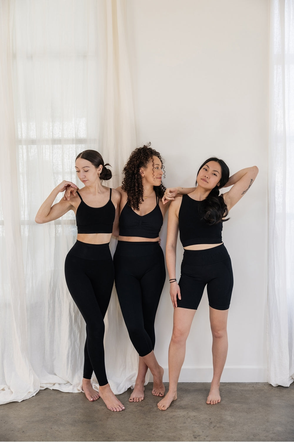 Models wearing black leggings and supportive sports bras for sustainable activewear brand, Jilla.