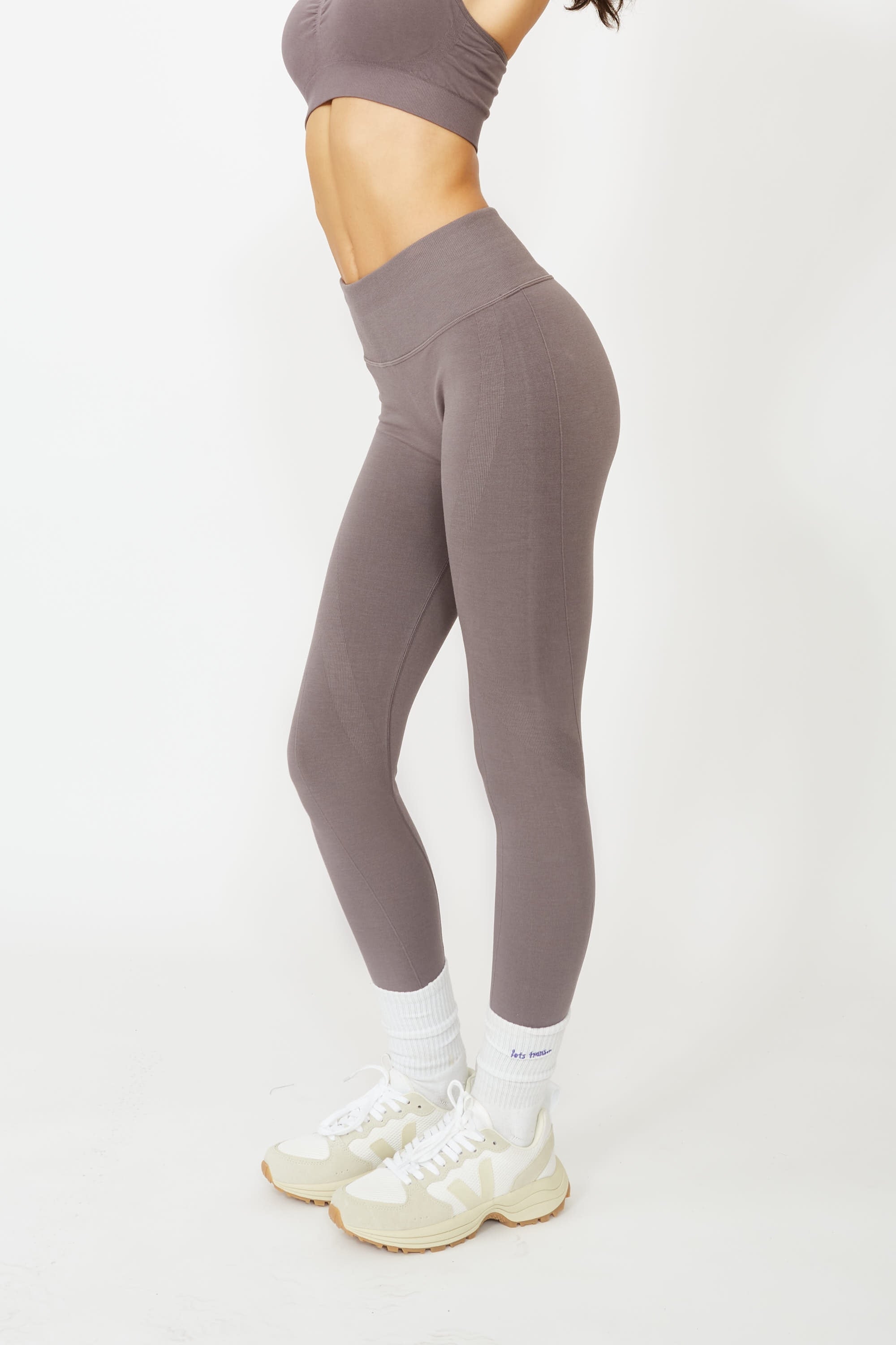 Model wearing grey leggings and supportive sports bra for sustainable activewear brand, Jilla.