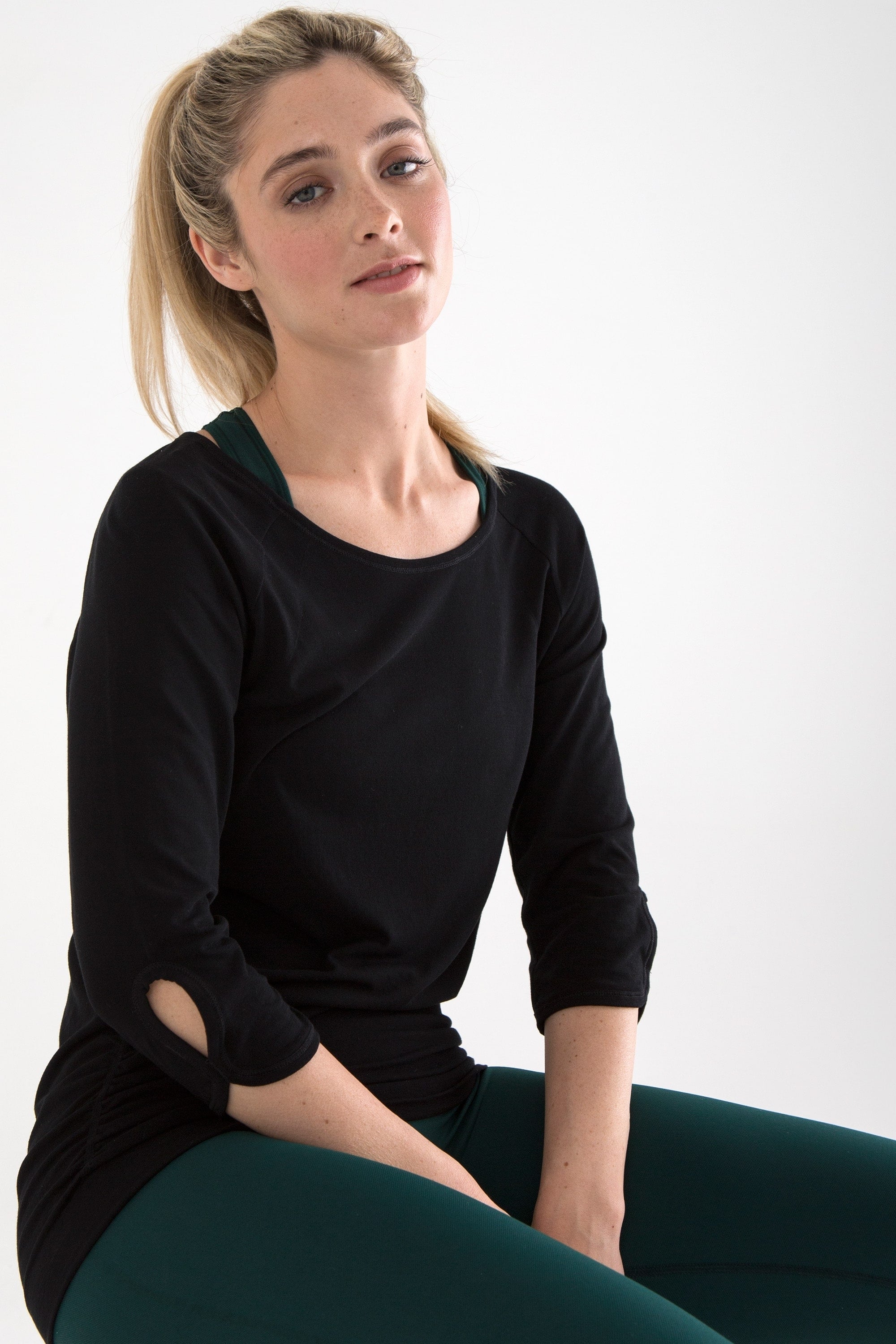 Black bamboo long sleeve top and dark pine green leggings for yoga, pilates, barre and running from sustainable activewear brand, Jilla Active