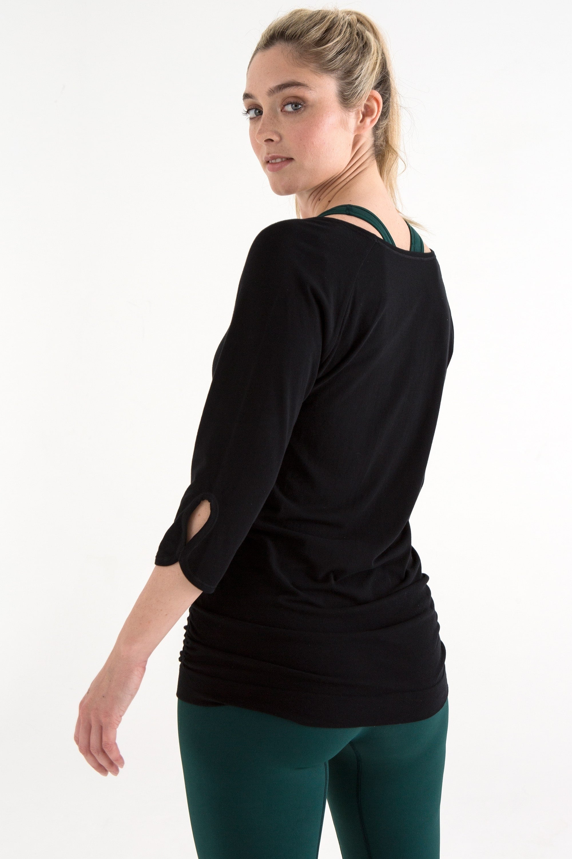 Black bamboo long sleeve top and dark pine green leggings for yoga, pilates, barre and running from sustainable activewear brand, Jilla Active