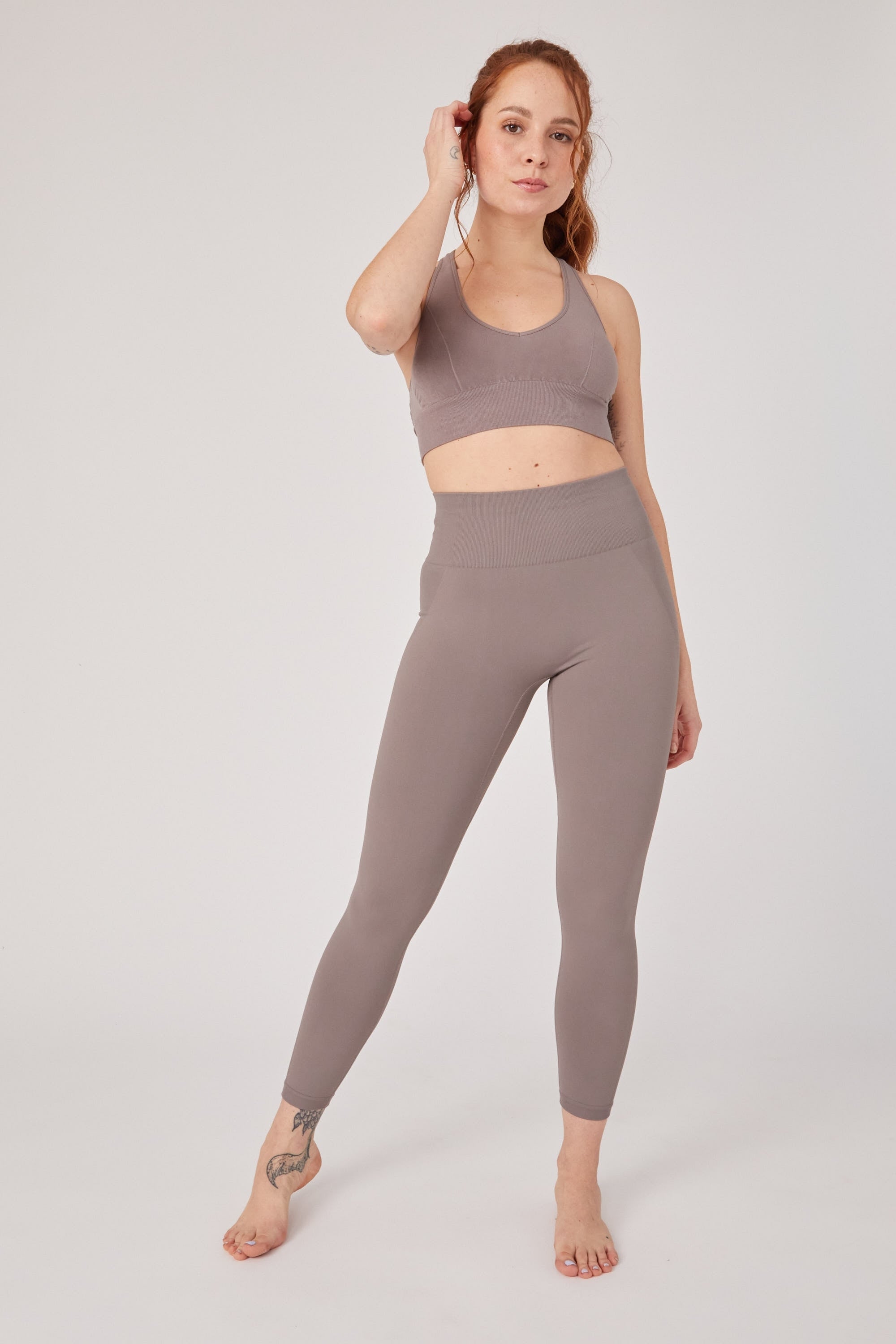 Model wearing grey yoga leggings for sustainable activewear brand, Jilla